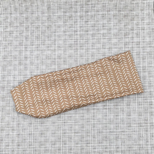 brown headband with white patterned lines