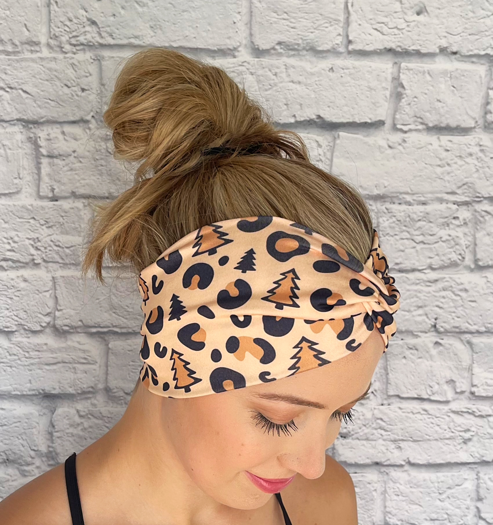 tan headband with black cheetah print and Christmas trees