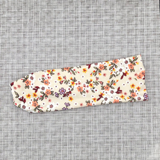 cream color headband with pink, red, yellow, and purple flowers