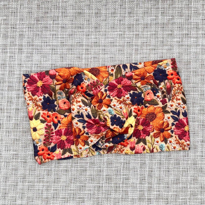 Wide, twisted headband with faux embroidered, floral print.