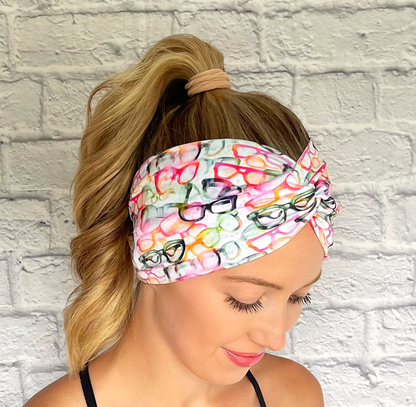 white, wide twist headband with glasses in rainbow colors