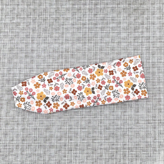 white headband with orange, pink, and yellow flowers