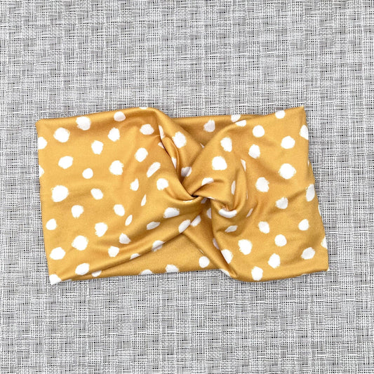 gold, wide twist headband with white spots