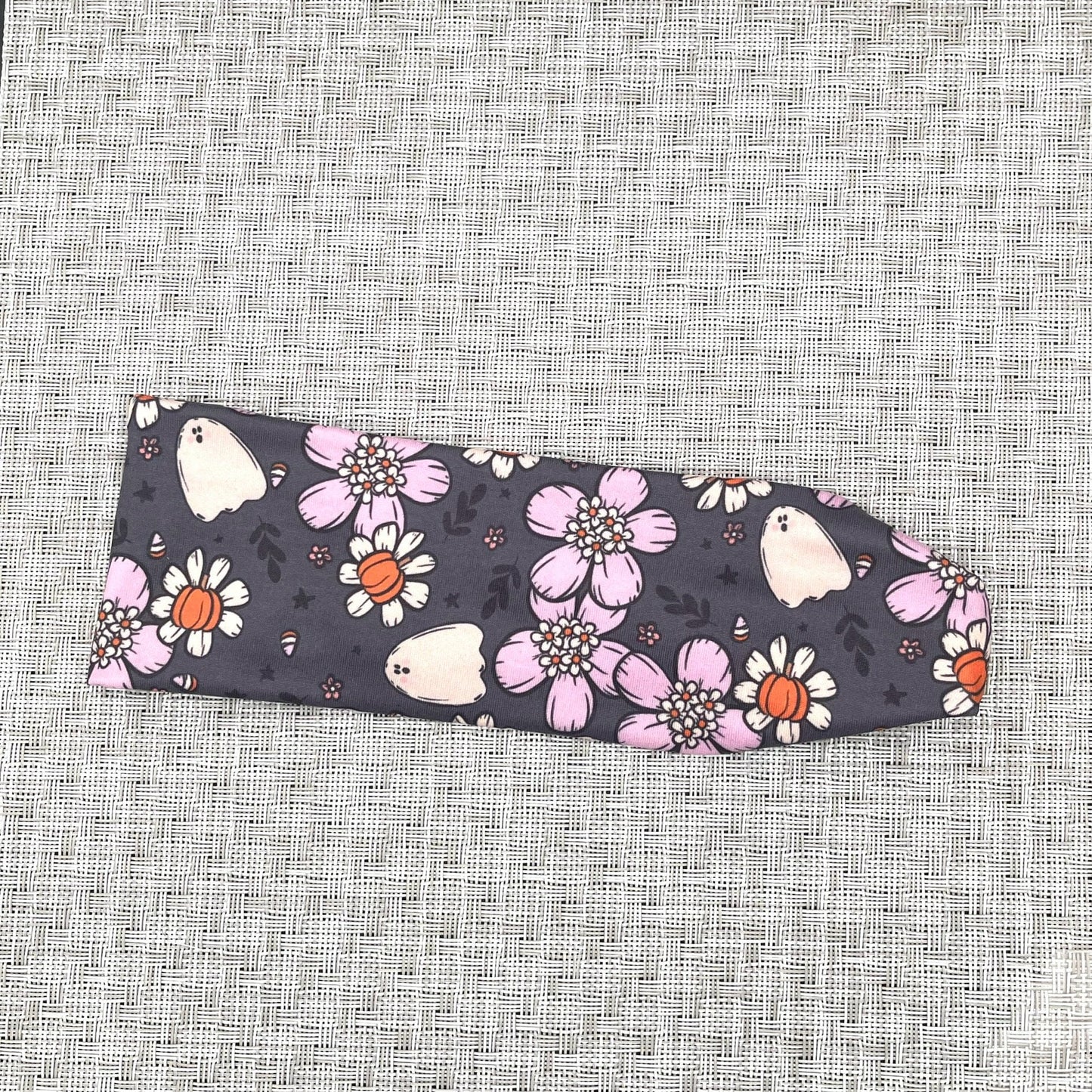 gray headband with white and purple flowers, pumpkins, and ghosts