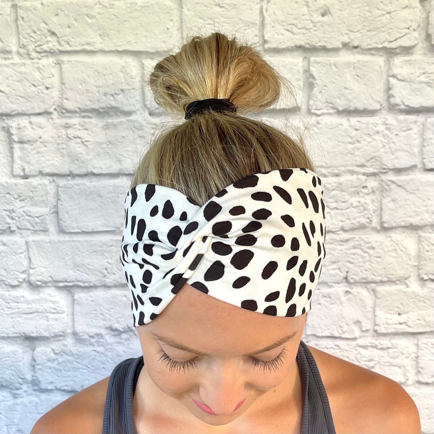 white, wide twist headband with black dalmation print spots