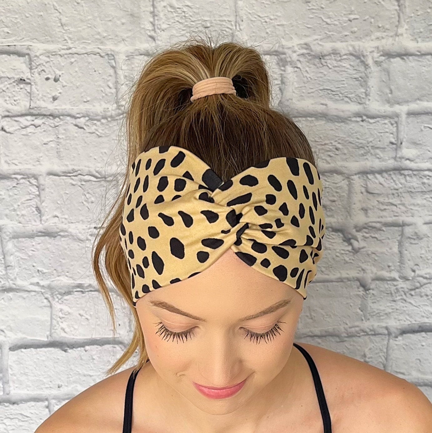 wide twist, tan headband with black dalmation spot print