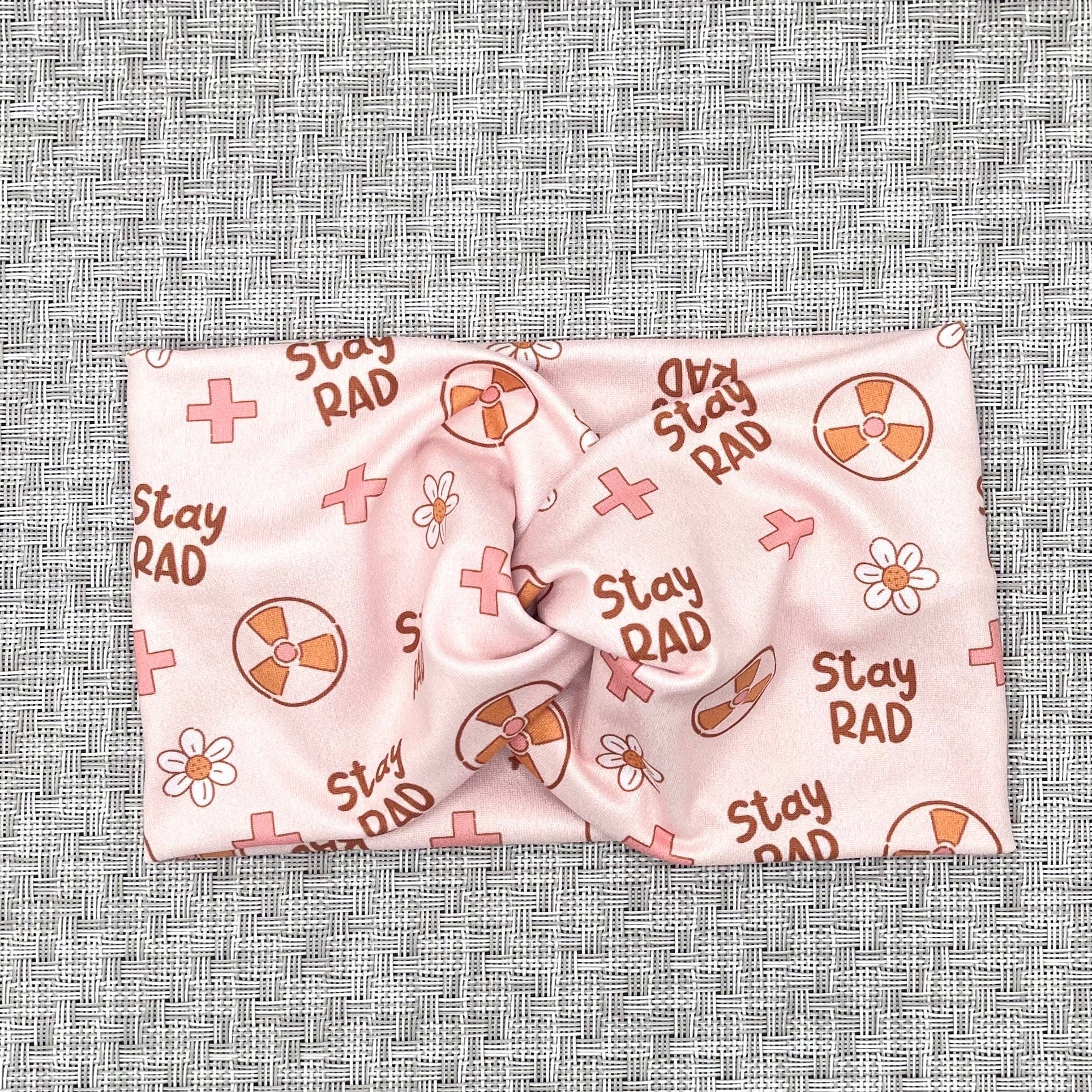 pink headband with "stay rad" print, radiology theme print, and flowers