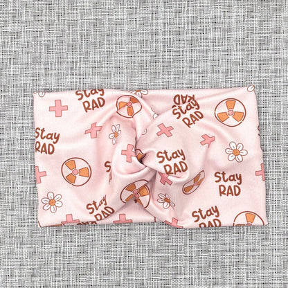 pink headband with "stay rad" print, radiology theme print, and flowers