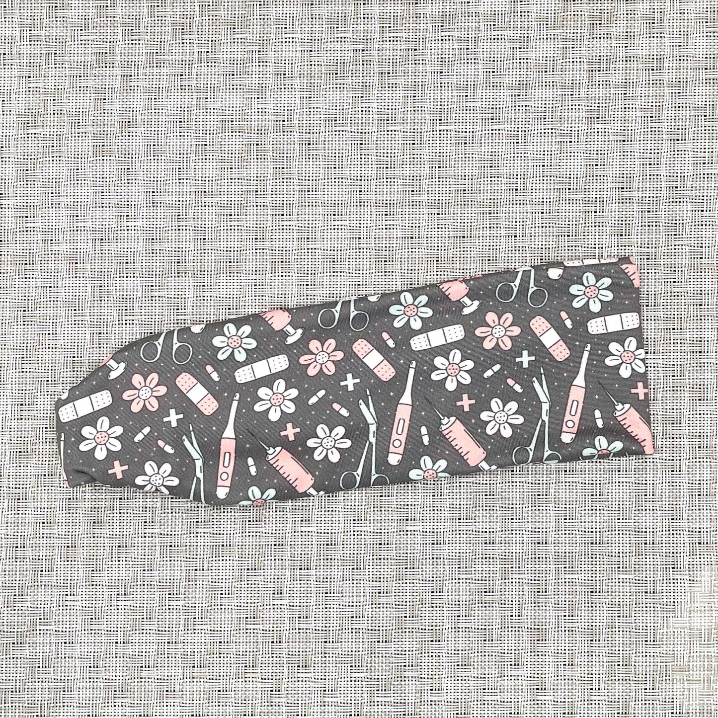 gray headband with pink, white, and seafoam green color medical theme print