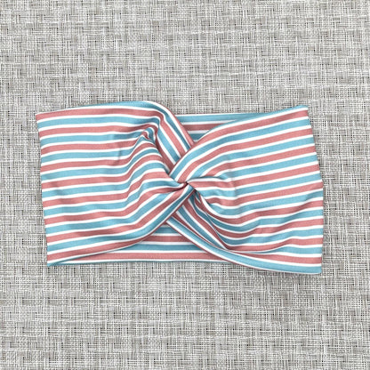 Wide, twisted headband with pink, blue, and white, stripe print.