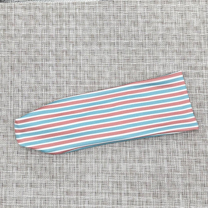 Flat, stretchy headband with pink, blue, and white striped print.