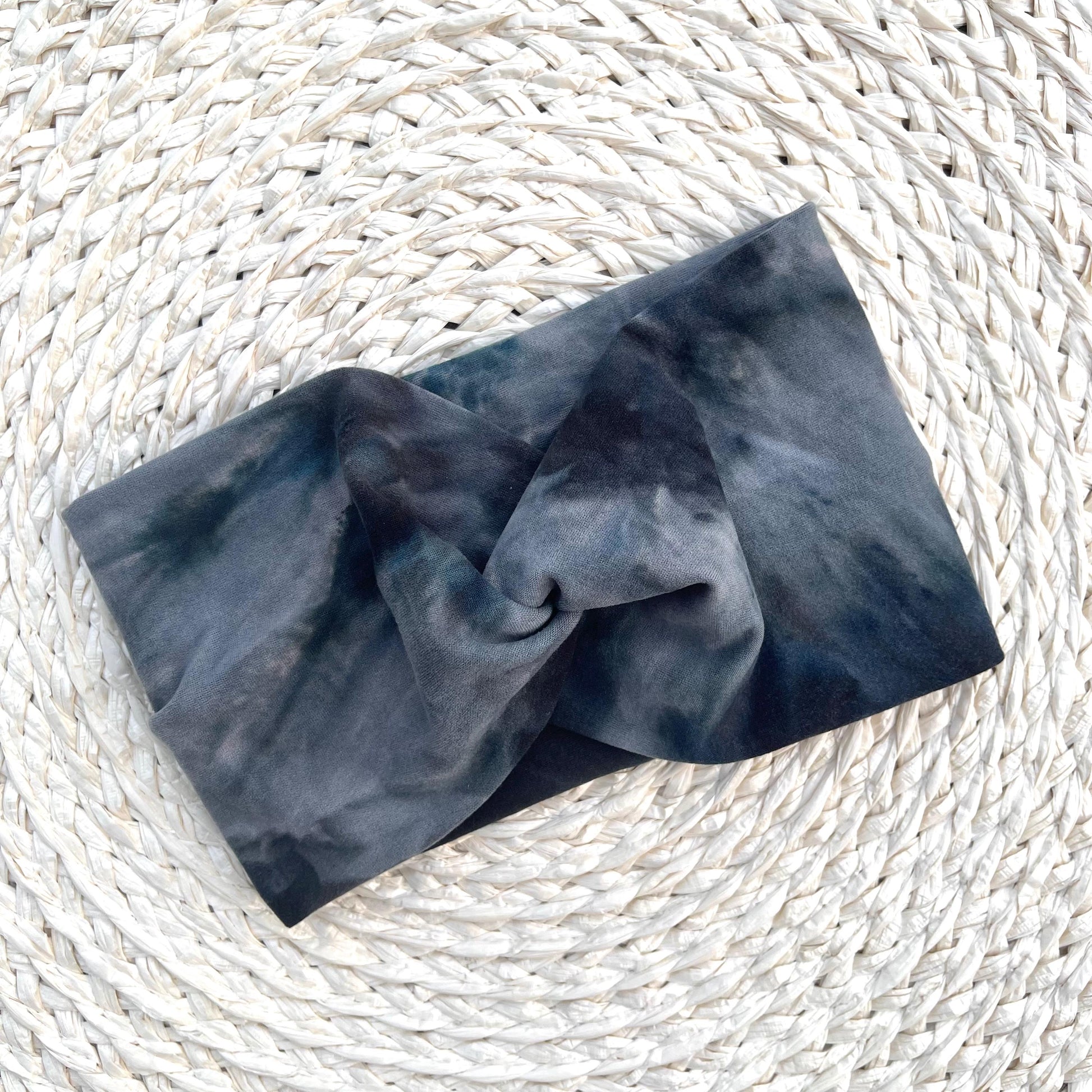 Wide, twisted headband in black, gray, silver tie dye print.