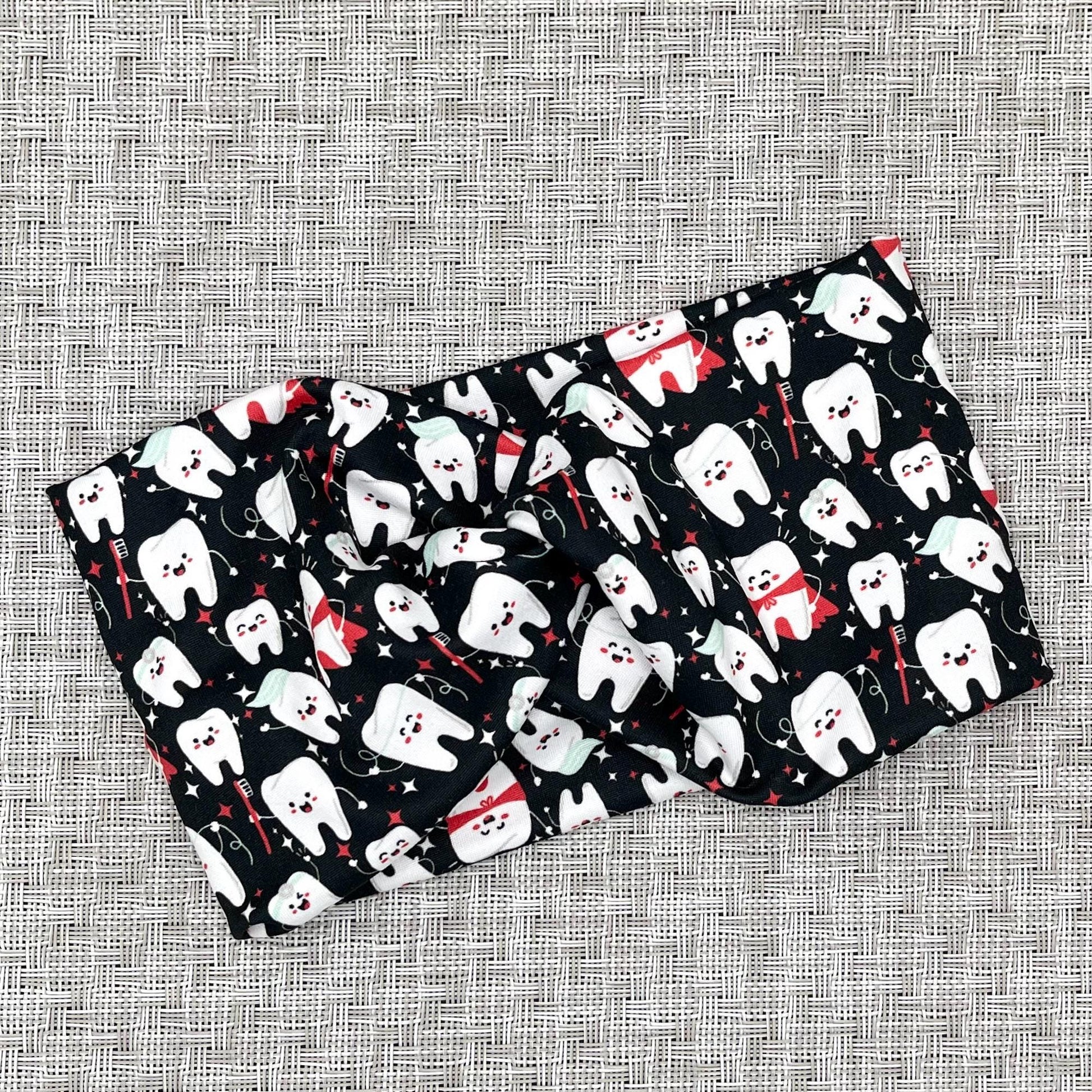Wide, twisted headband in black with white dental theme print.