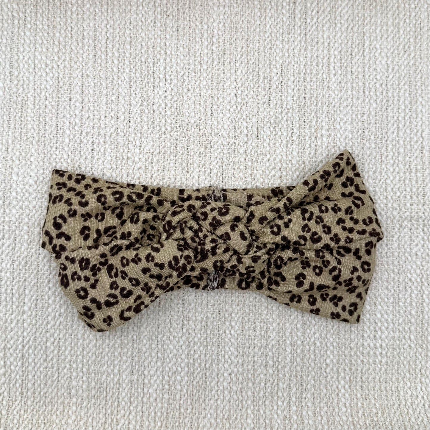 Sailor knot style headband with ribbed fabric in brown with black cheetah print.