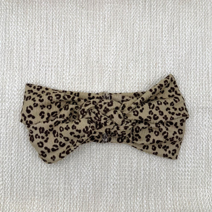 Sailor knot style headband with ribbed fabric in brown with black cheetah print.