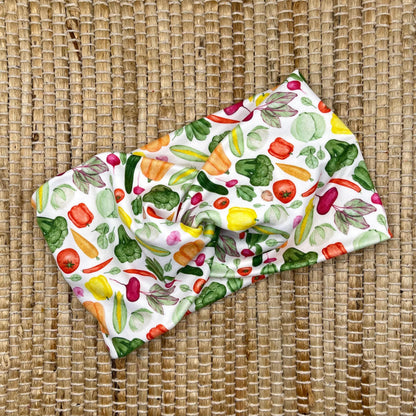 Wide, twisted headband in white with vegetable theme print.