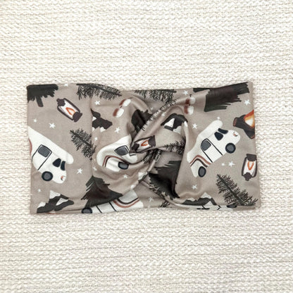 Wide, twisted headband in tan with camping theme print.