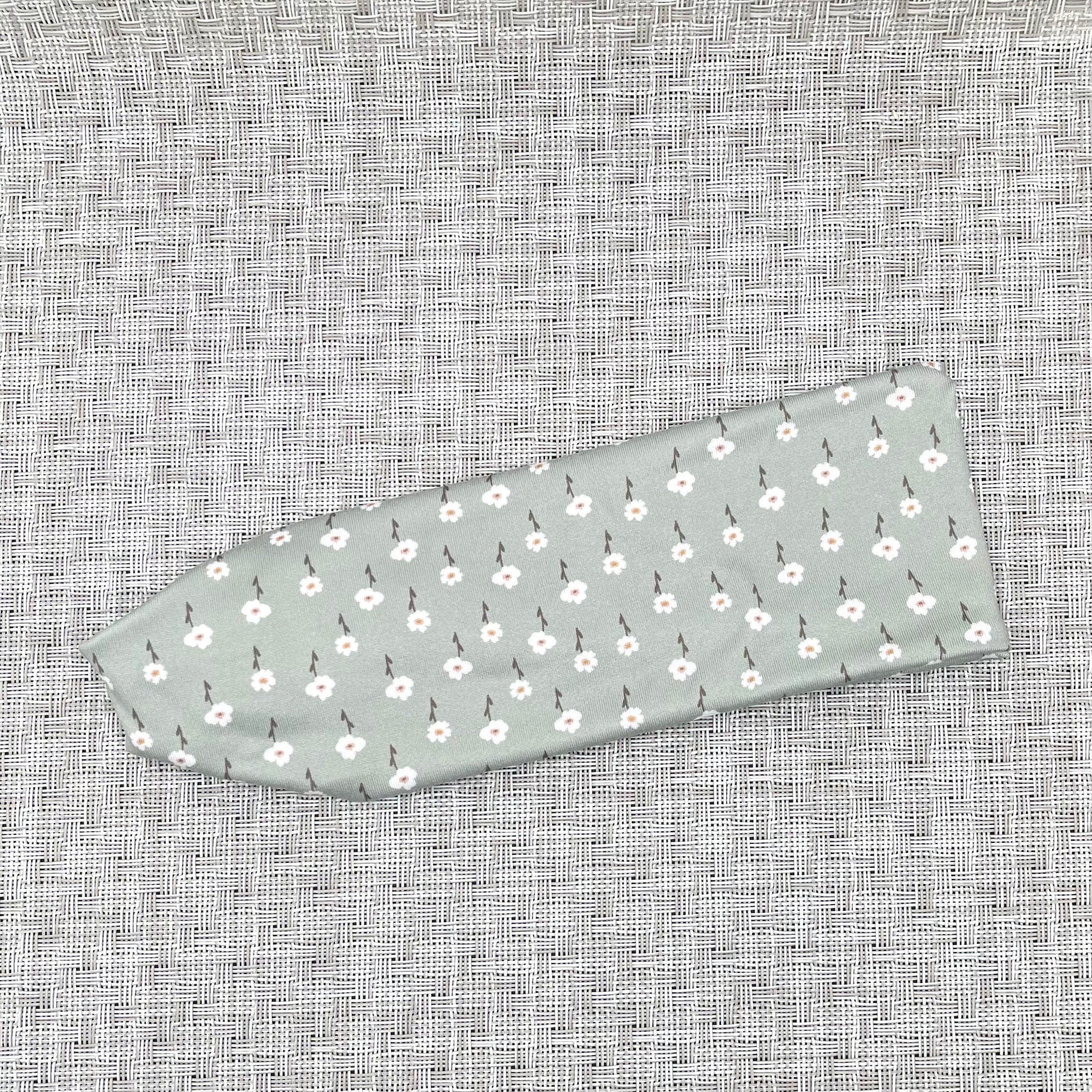 mint color headband with small white flowers