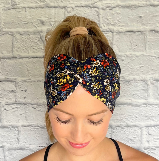 navy wide twist headband with red, white, yellow, and blue flowers