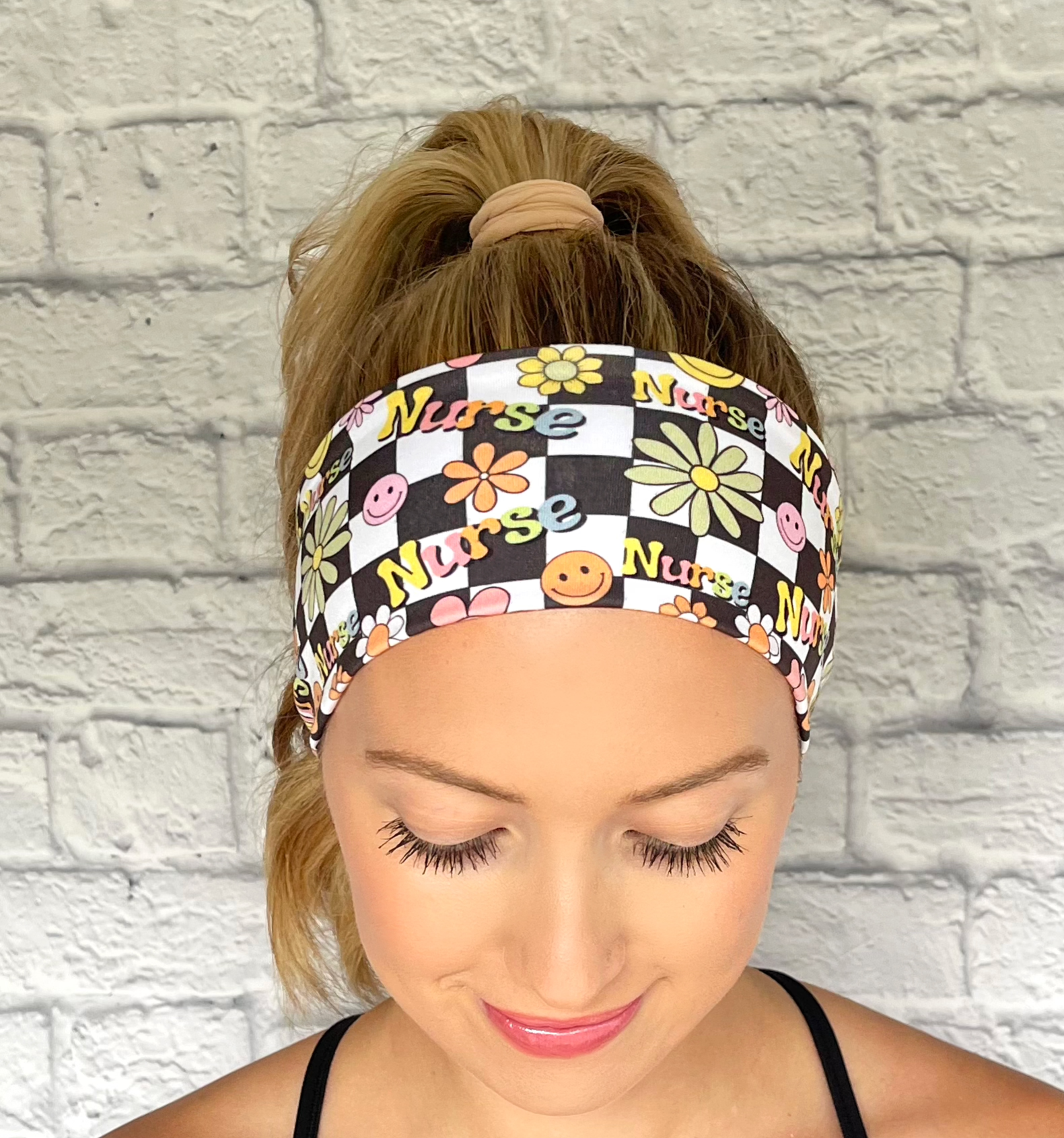 black and white checker print headband with "nurse" print and flowers in rainbow colors