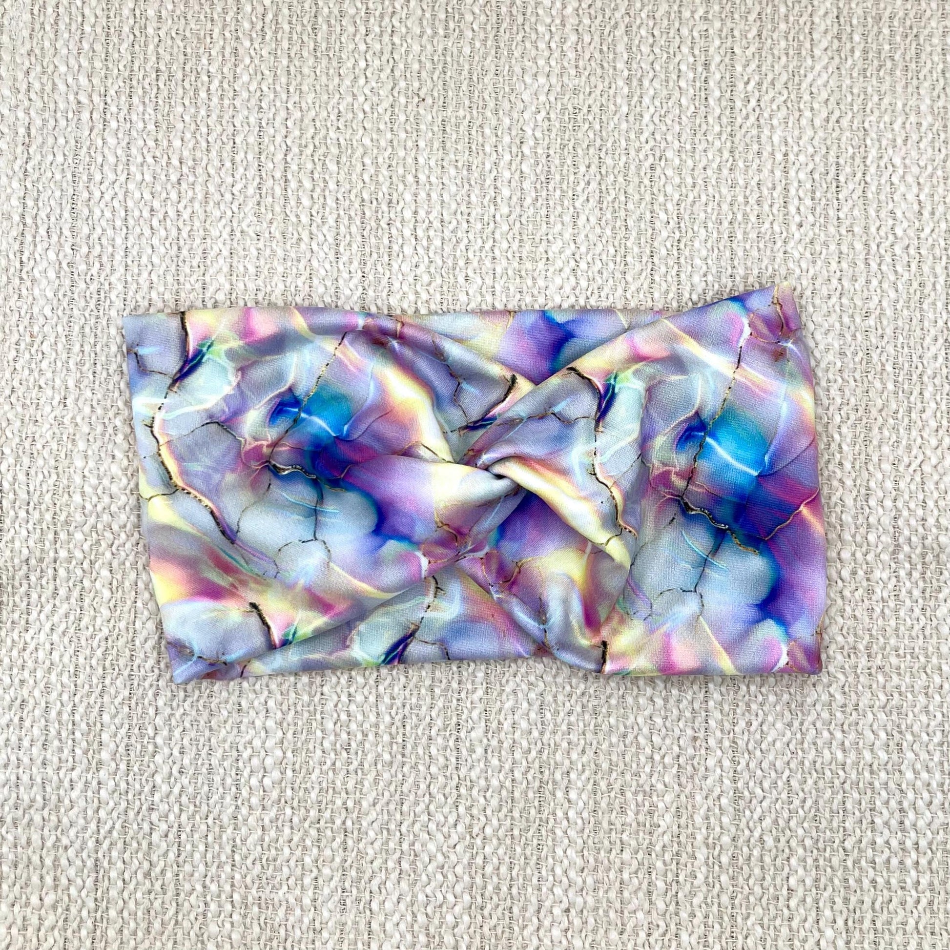 Wide, twisted headband with multi-color watercolor print.
