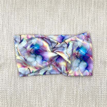 Wide, twisted headband with multi-color watercolor print.