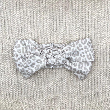 Tan and white cheetah print headband in sailor knot style with ribbed fabric.