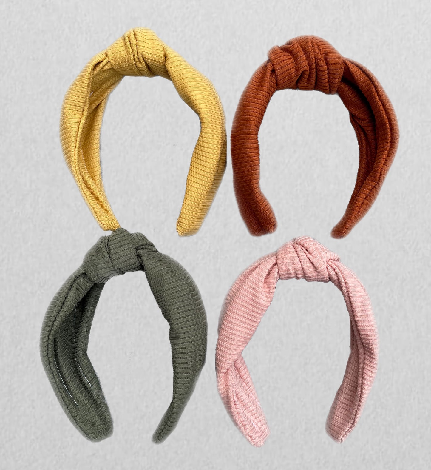 Top knot, hard headbands in varying colors- mustard yellow, light pink, olive green, and burnt orange.