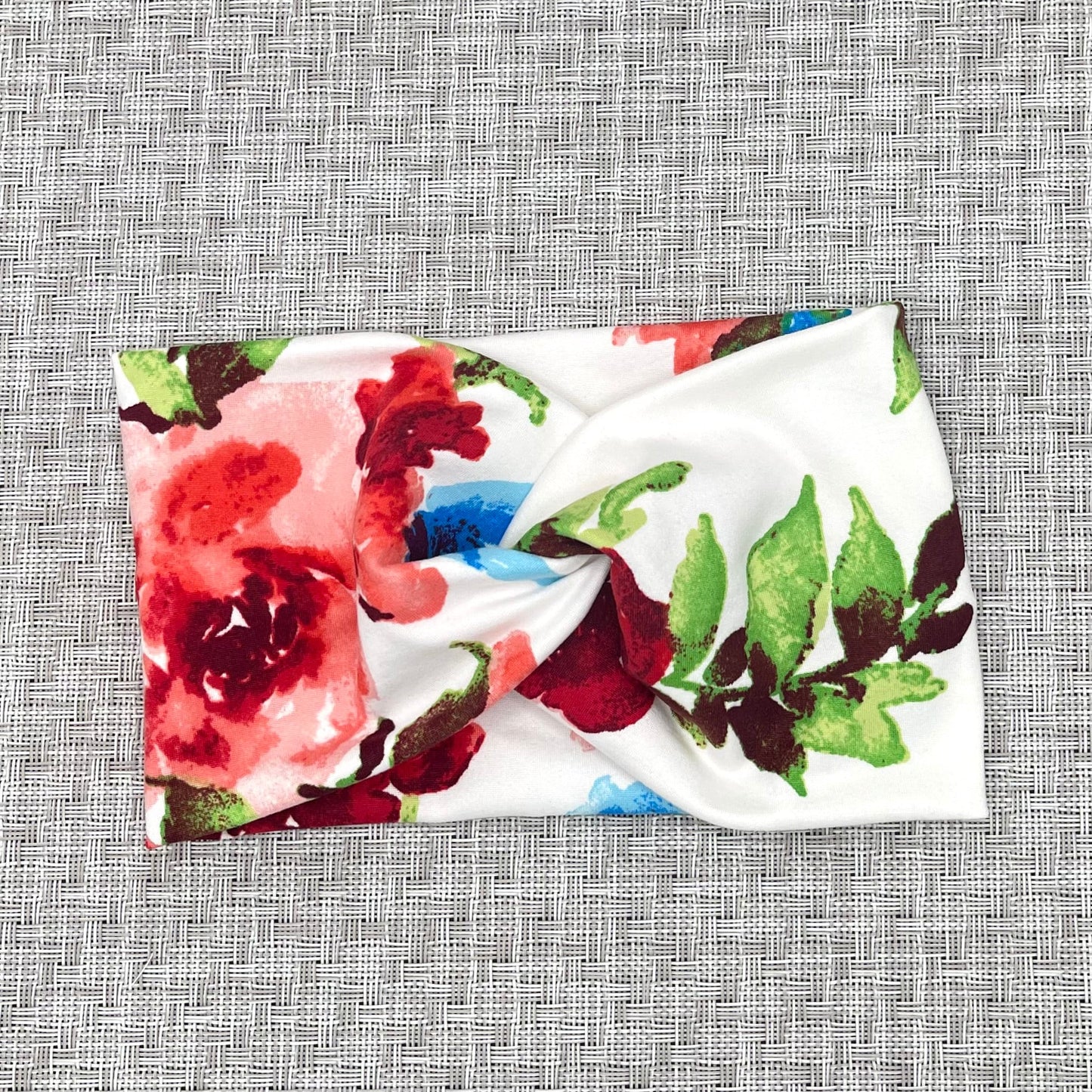 wide white headband with twist and a red and blue floral print