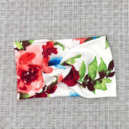 wide white headband with twist and a red and blue floral print