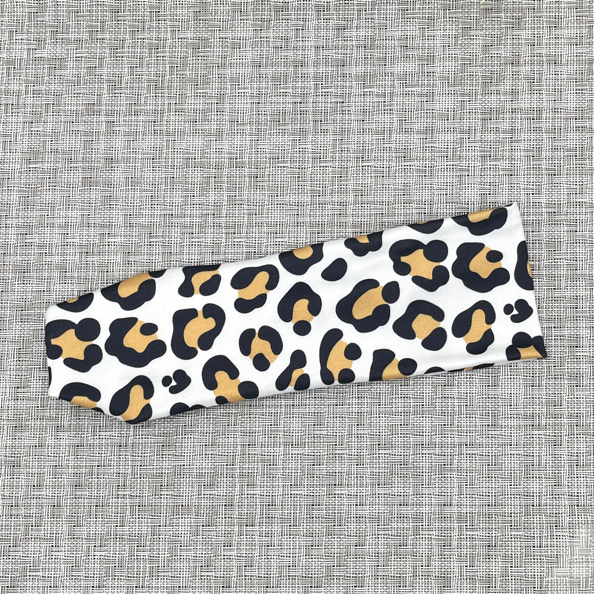 white headband with tan and black cheetah print