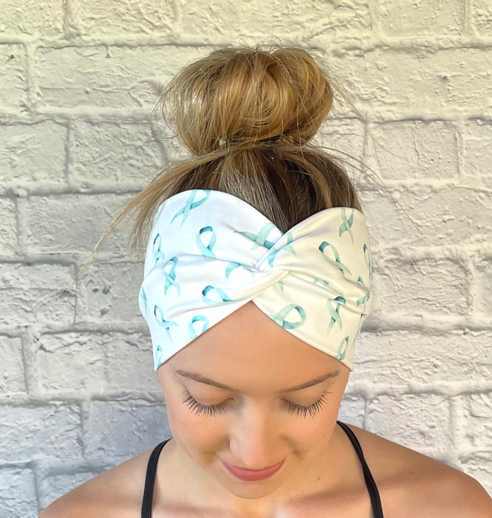 white headband with teal ribbon awareness