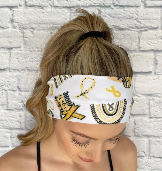 white headband with gold ribbon awareness