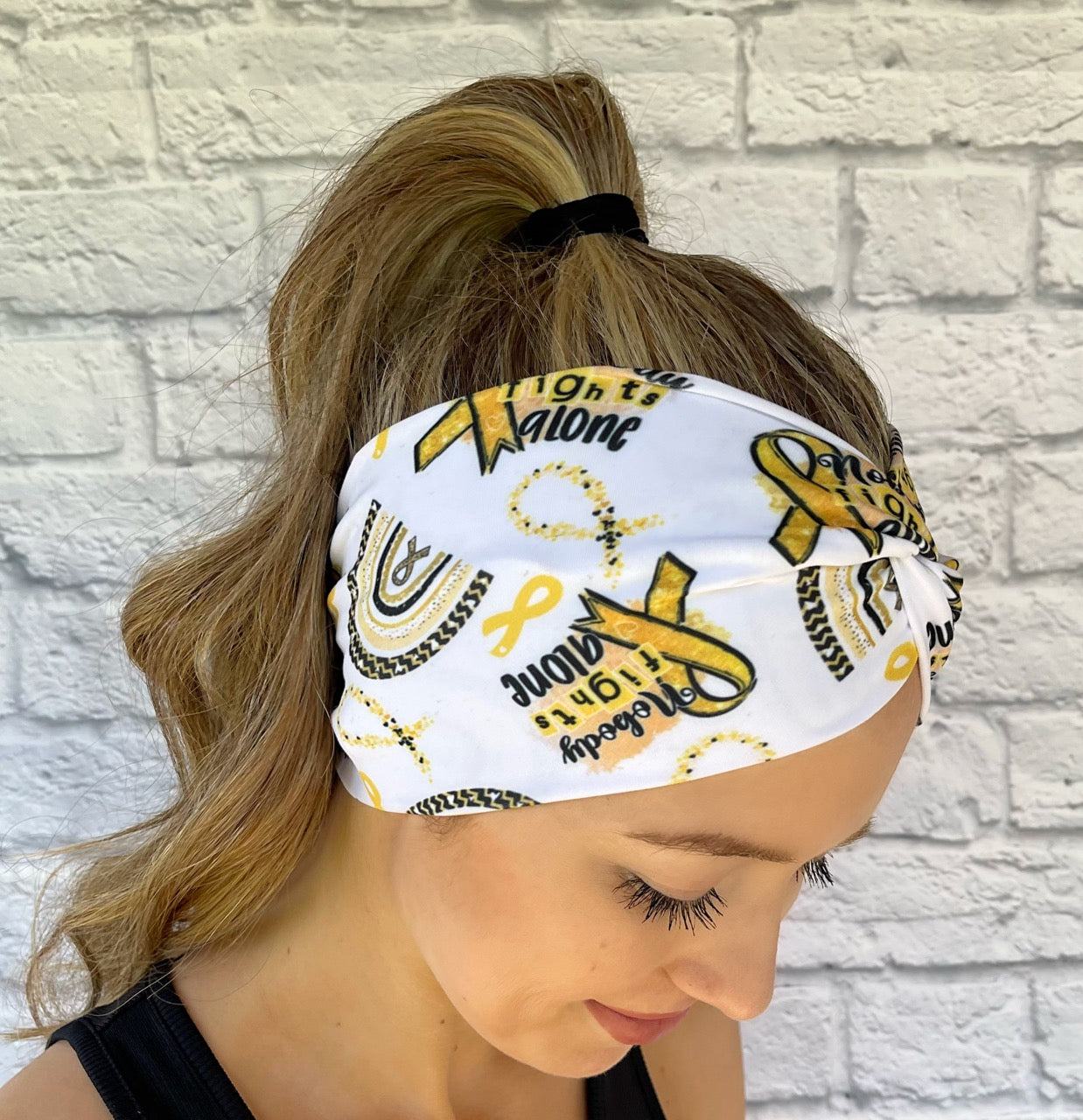 wide white headband with gold childhood cancer awareness