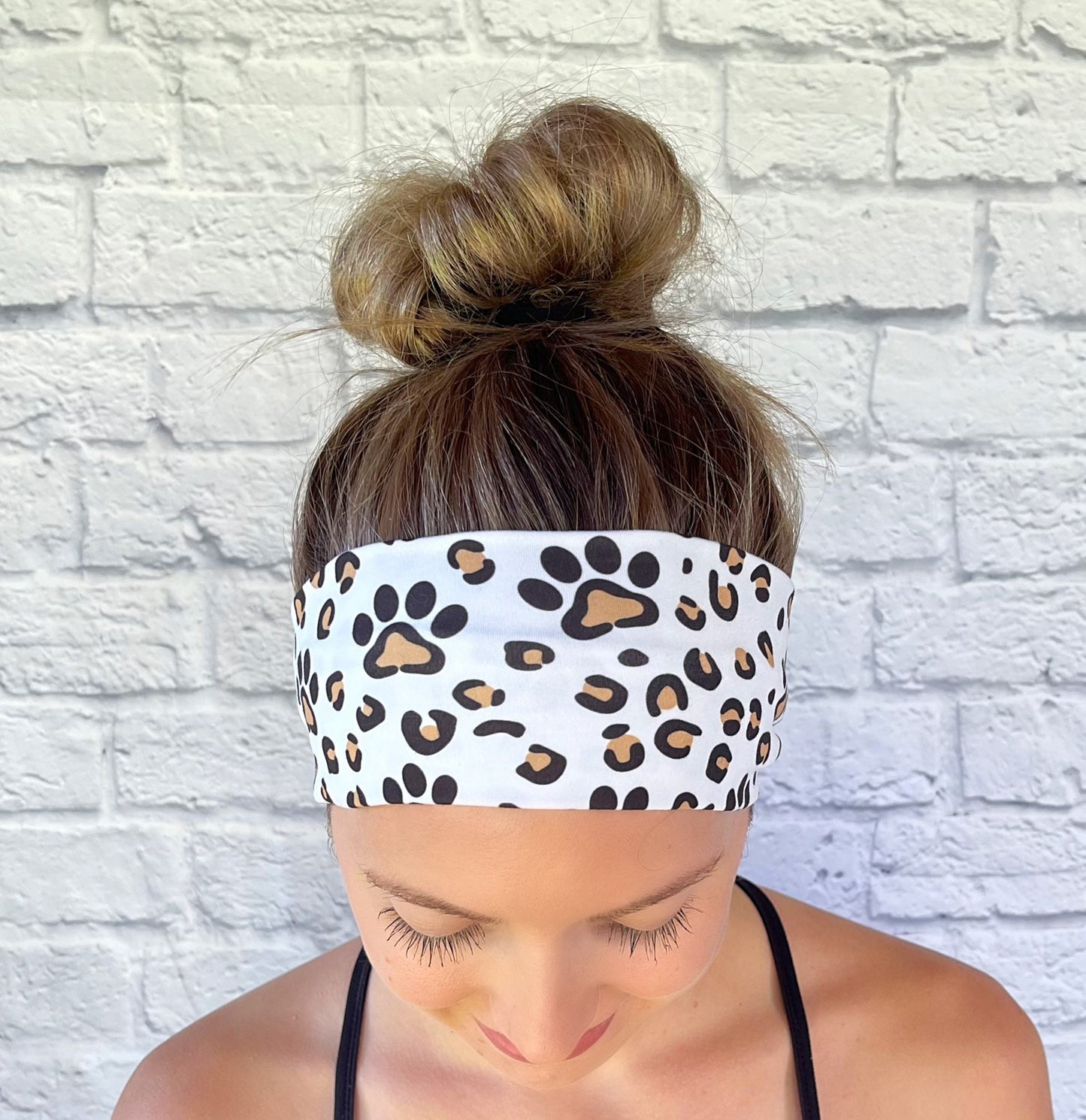 white headband with brown dog paws