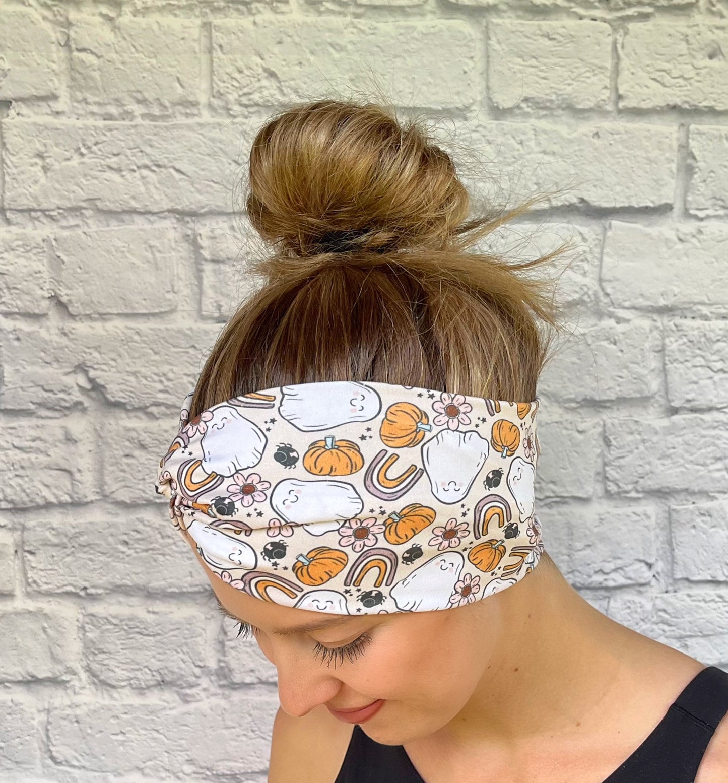 tan headband with ghosts, rainbows, and pumpkins