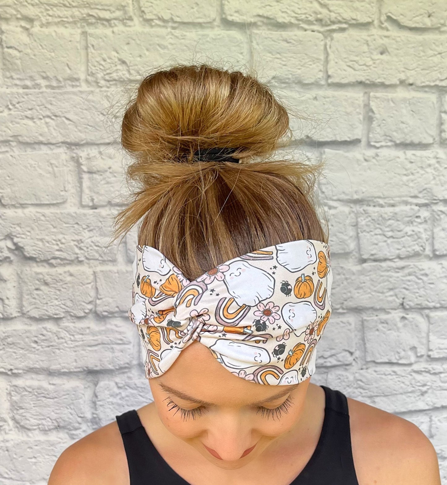 tan headband with ghosts, rainbows, and pumpkins