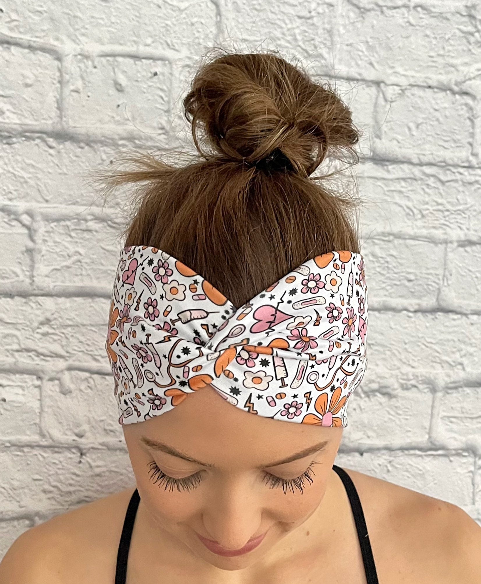 white headband with orange and pink flowers and medical theme print