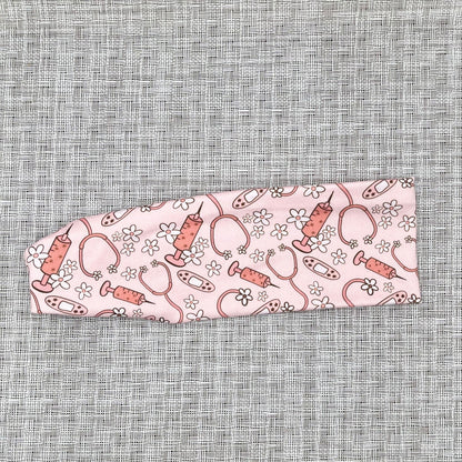 pink headband with medical theme print and flowers