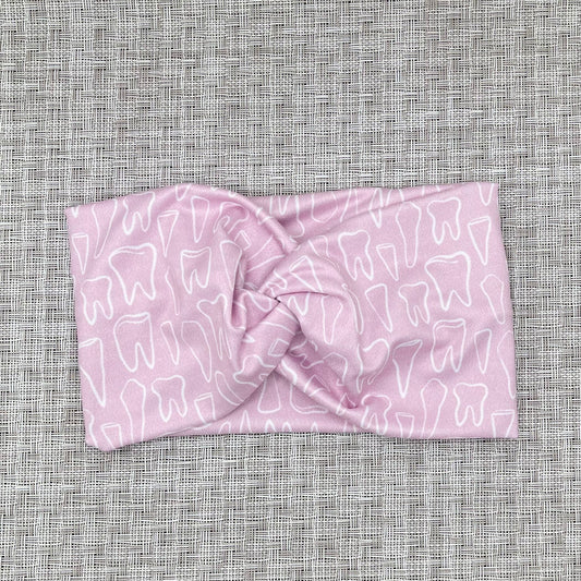 pink headband with white teeth