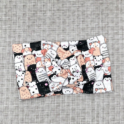 white, black, and peach headband with cats and dogs